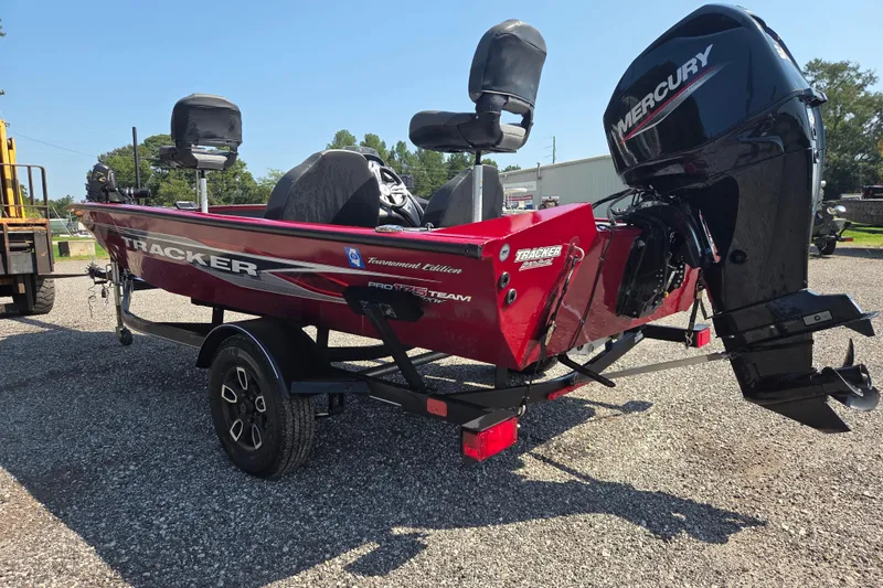 Slide: The Image of 2022 Tracker Pro Team 175 TXW boat with Mercury engine on trailer, parked outdoors. - 5