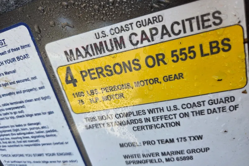 Slide: The Image of 2022 Tracker Pro Team 175 TXW boat capacity label, 4 persons or 555 lbs limit. - 8