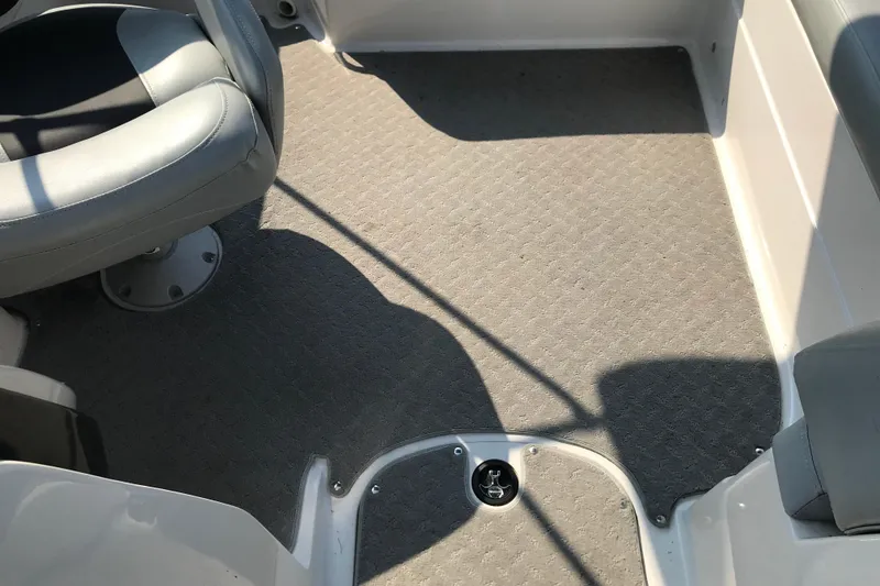 Slide: The Image of Interior of 2012 Starcraft Crossover 220 SCX IO boat with gray seating and carpet. - 13