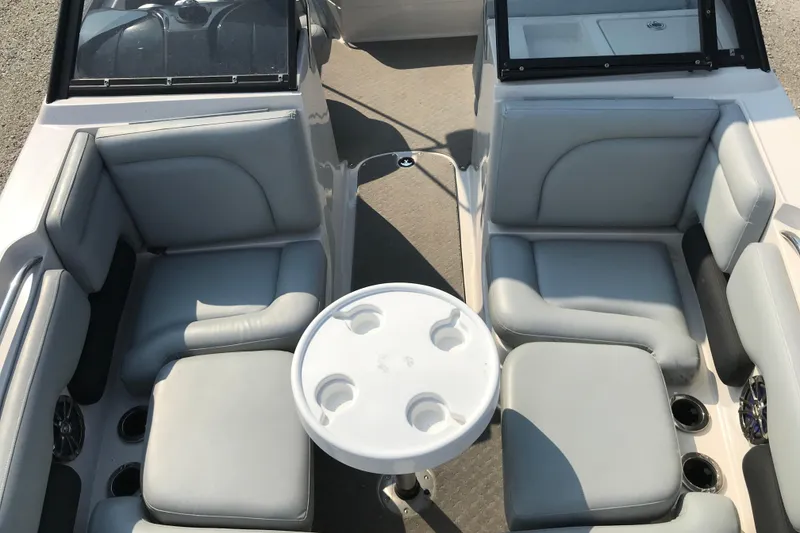 Slide: The Image of 2012 Starcraft Crossover 220 SCX IO boat interior with gray seating and round table. - 14