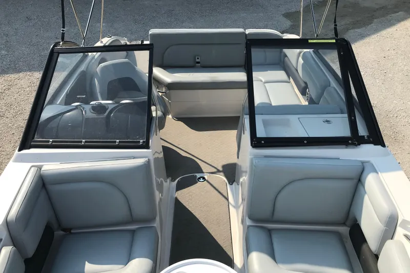 Slide: The Image of 2012 Starcraft Crossover 220 SCX IO boat interior with gray seating and open windshield. - 15