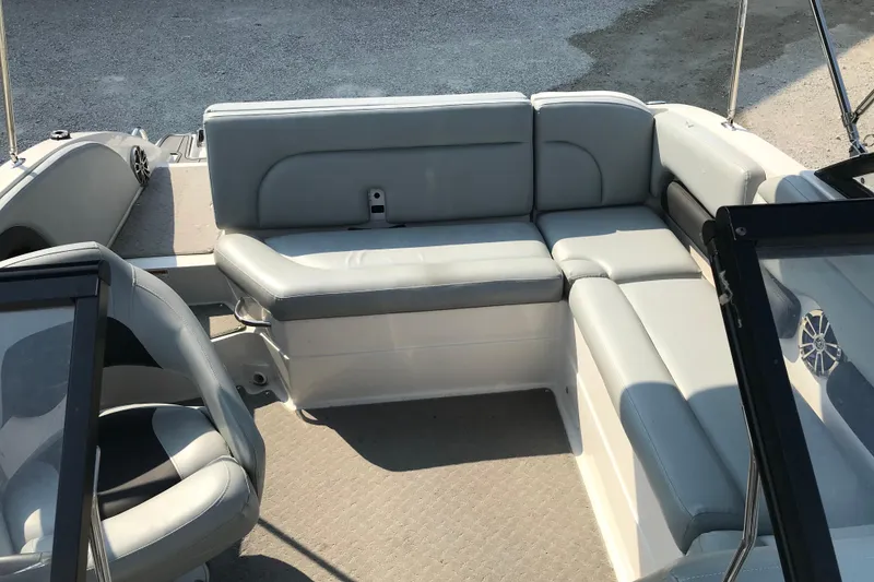 Slide: The Image of 2012 Starcraft Crossover 220 SCX IO boat interior with gray seating and steering area. - 16