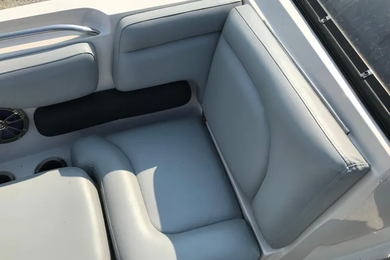 Slide: The Image of 2012 Starcraft Crossover 220 SCX IO boat interior seating, featuring light gray upholstery. - 19