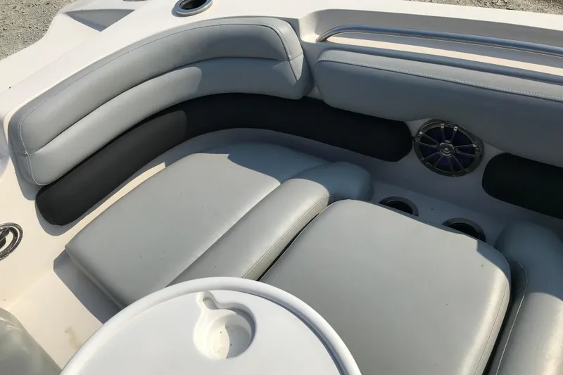 Slide: The Image of 2012 Starcraft Crossover 220 SCX IO boat interior with gray seating and speaker. - 21