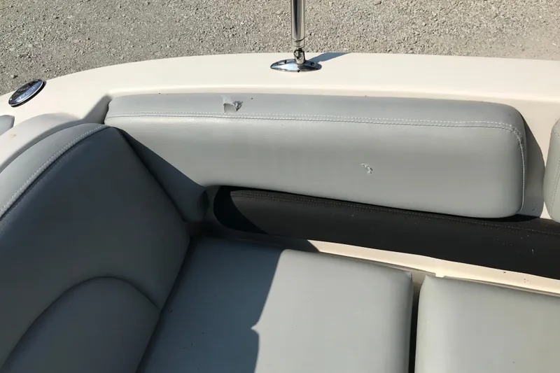 Slide: The Image of 2012 Starcraft Crossover 220 SCX IO boat interior with light gray seating. - 23