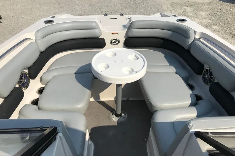 Slide: The Image of 2012 Starcraft Crossover 220 SCX IO boat interior with cushioned seating and table. - 28