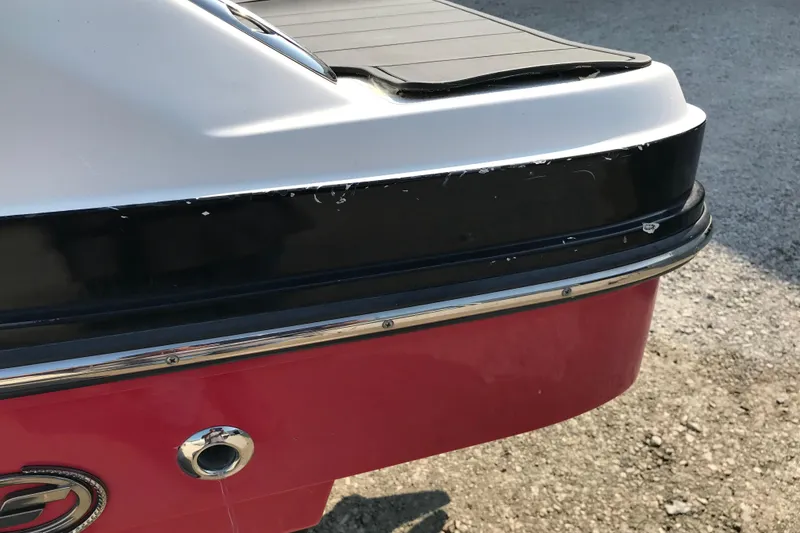 Slide: The Image of 2012 Starcraft Crossover 220 SCX IO boat stern detail with red and black finish. - 30