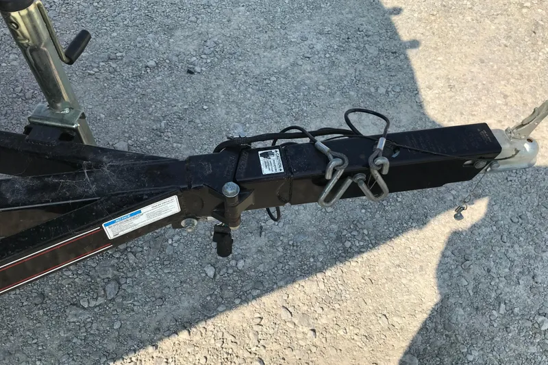 Slide: The Image of Trailer hitch of 2012 Starcraft Crossover 220 SCX IO on gravel surface. - 31