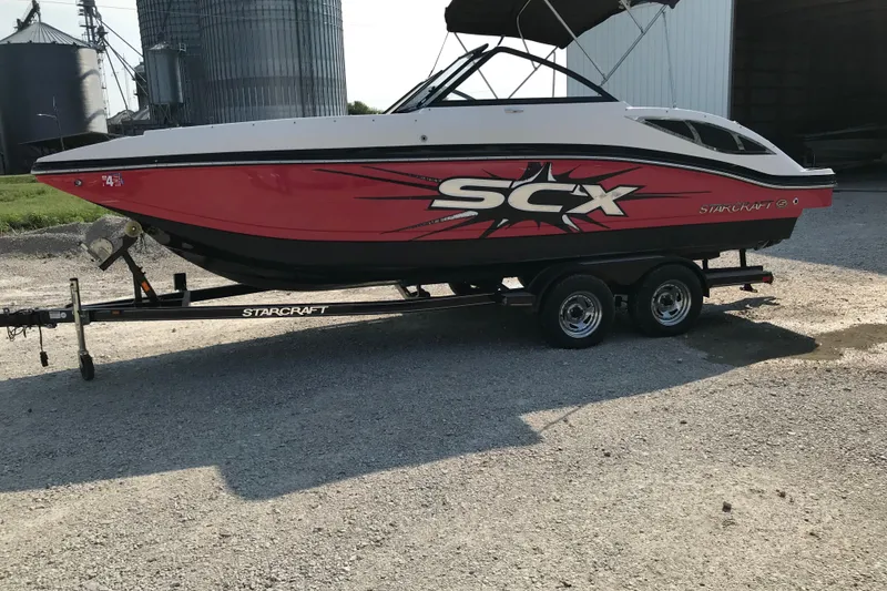 Slide: The Image of 2012 Starcraft Crossover 220 SCX IO boat on trailer, red and white design. - 4