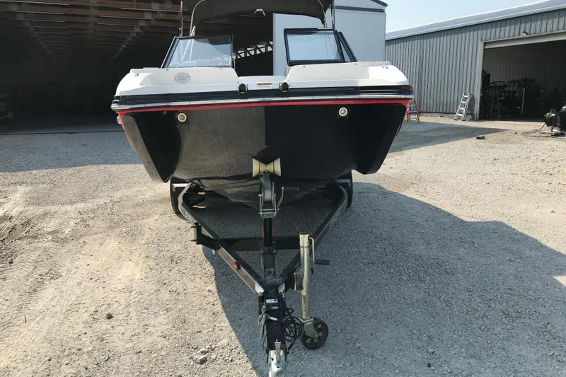 Slide: The Image of 2012 Starcraft Crossover 220 SCX IO boat on trailer in gravel lot. - 5