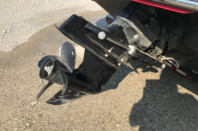 Slide: The Image of 2012 Starcraft Crossover 220 SCX IO boat propeller and outdrive on gravel surface. - 8