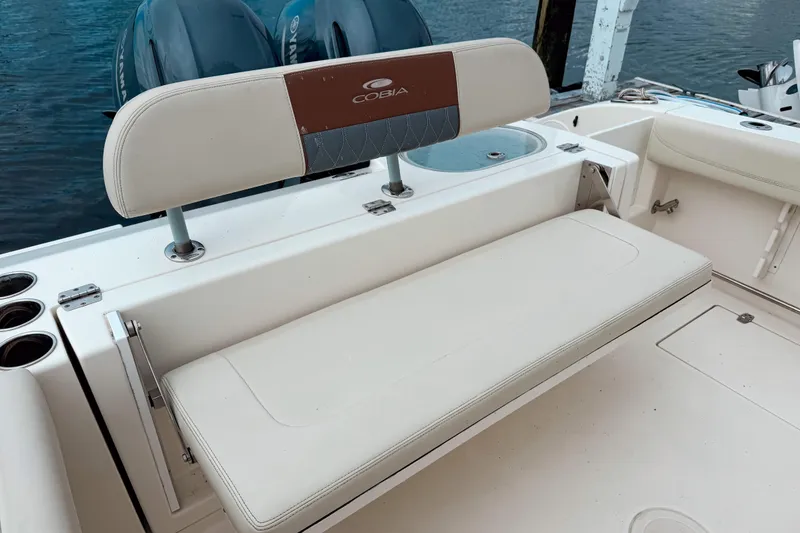 Slide: The Image of 2018 Cobia 261 Center Console boat with cushioned seating and dual Yamaha engines. - 5