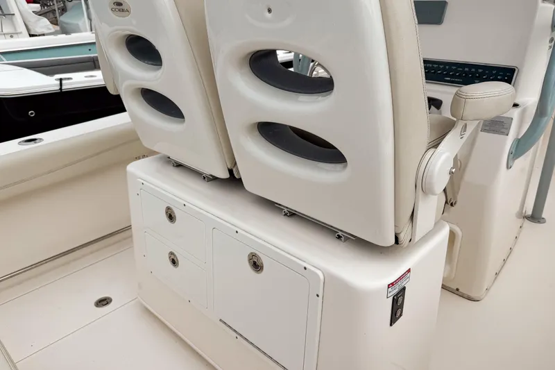 Slide: The Image of 2018 Cobia 261 Center Console boat interior with dual seats and storage compartments. - 7