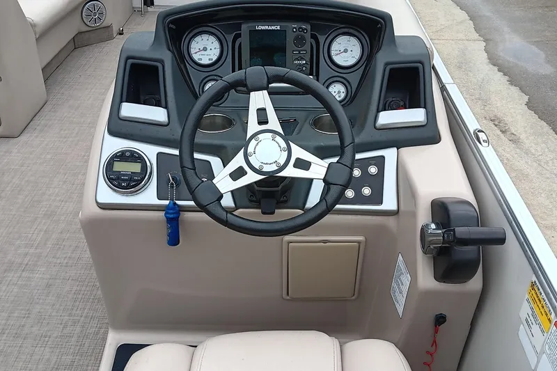 Slide: The Image of 2017 Ranger Reata 220C boat dashboard with steering wheel and control panel. - 11
