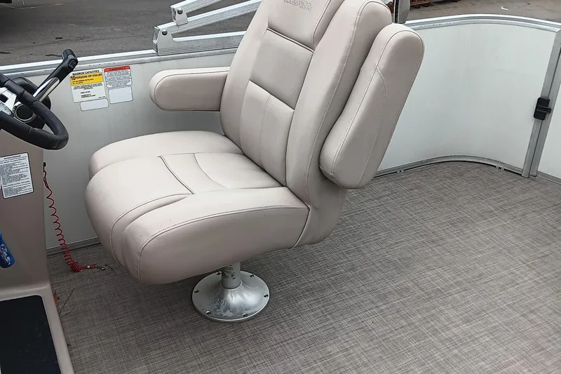 Slide: The Image of 2017 Ranger Reata 220C boat captain's chair with beige upholstery and armrests. - 12