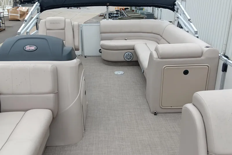 Slide: The Image of 2017 Ranger Reata 220C pontoon boat interior with beige seating and spacious layout. - 13