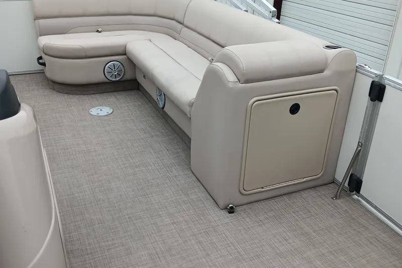 Slide: The Image of 2017 Ranger Reata 220C boat interior with beige seating and carpeted floor. - 14