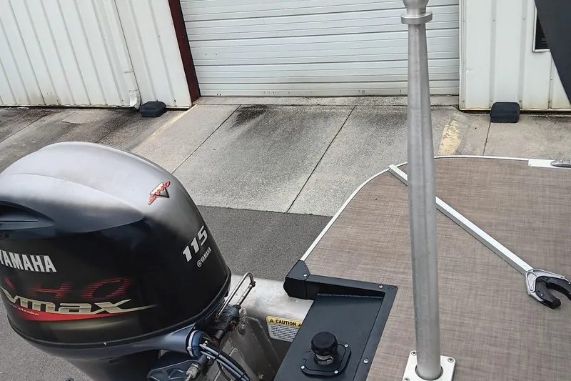 Slide: The Image of 2017 Ranger Reata 220C boat with Yamaha 115 VMAX outboard motor, docked near a garage. - 15