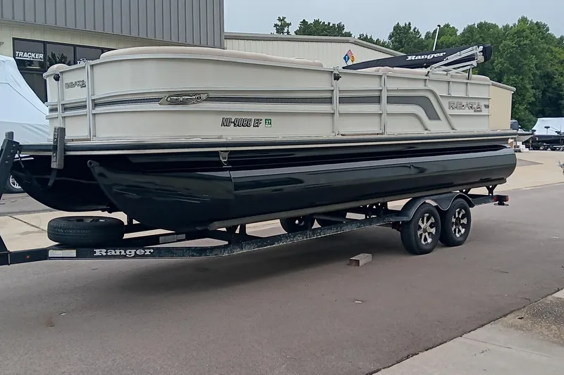 Slide: The Image of 2017 Ranger Reata 220C pontoon boat on trailer, parked outdoors. - 5