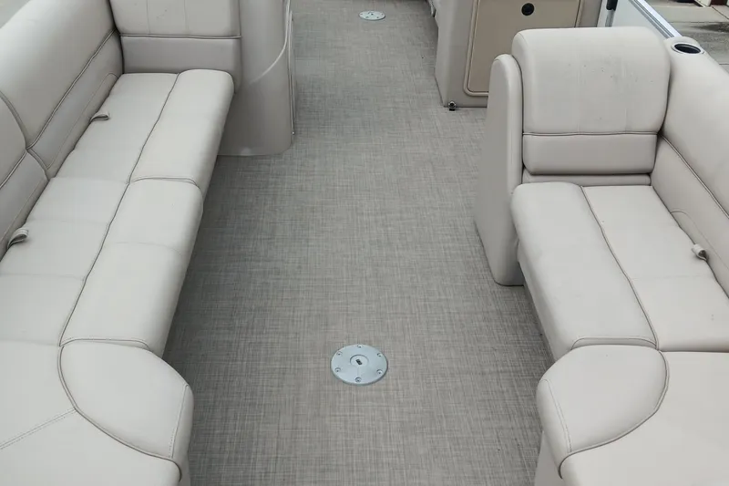 Slide: The Image of 2017 Ranger Reata 220C boat interior with beige seating and carpeted floor. - 7