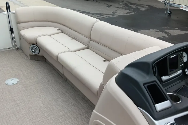 Slide: The Image of 2017 Ranger Reata 220C boat interior with beige seating and control panel. - 8