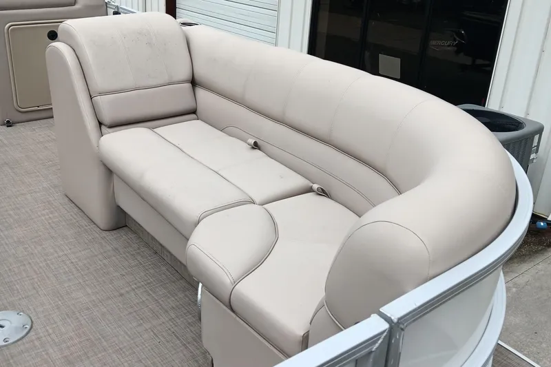 Slide: The Image of 2017 Ranger Reata 220C boat interior with beige cushioned seating. - 9