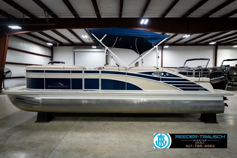 Slide: The Image of 2016 Bennington 2375 RSB pontoon boat with Mercury outboard in indoor showroom. - 10