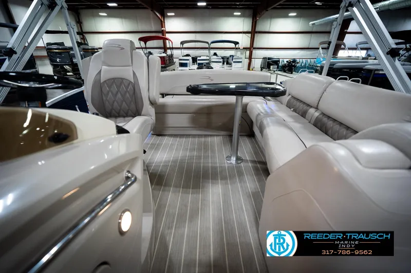 Slide: The Image of 2016 Bennington 2375 RSB pontoon boat interior with plush seating in showroom. - 16
