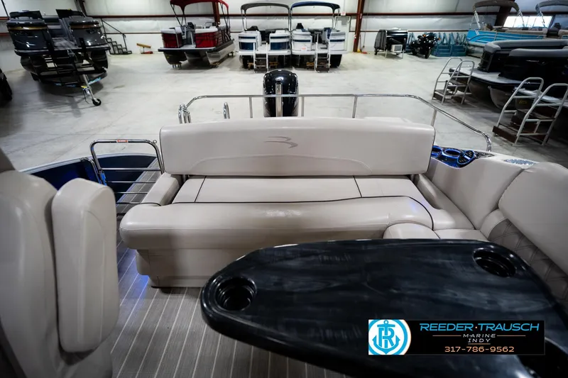 Slide: The Image of 2016 Bennington 2375 RSB pontoon boat interior with luxurious seating and table. - 17