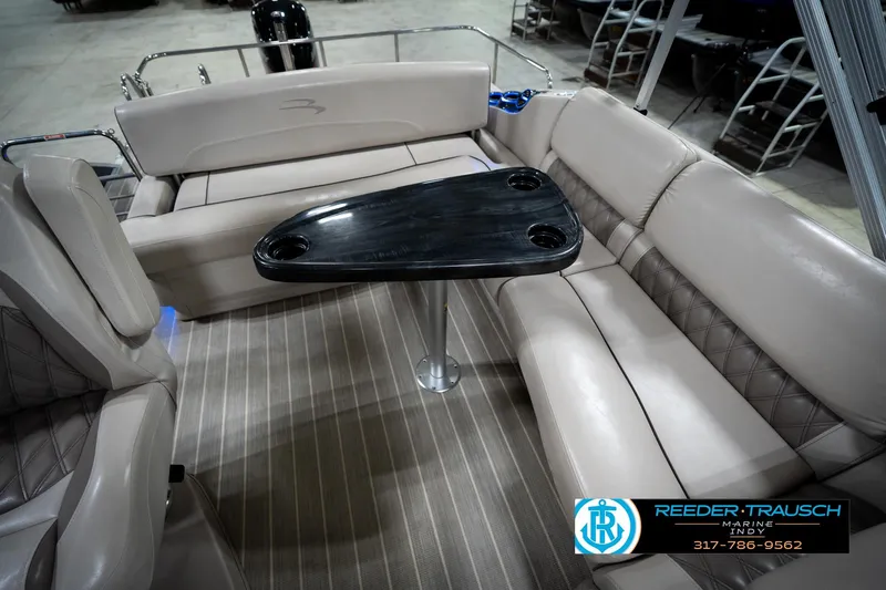 Slide: The Image of 2016 Bennington 2375 RSB boat interior with luxurious seating and storage compartment. - 24