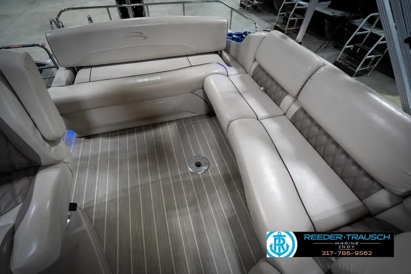 Slide: The Image of 2016 Bennington 2375 RSB boat interior with seating and table, showcased by Reeder-Trausch Marine. - 25