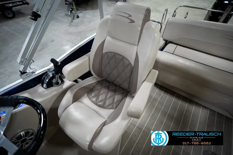 Slide: The Image of 2016 Bennington 2375 RSB boat interior with luxurious seating and steering controls. - 28