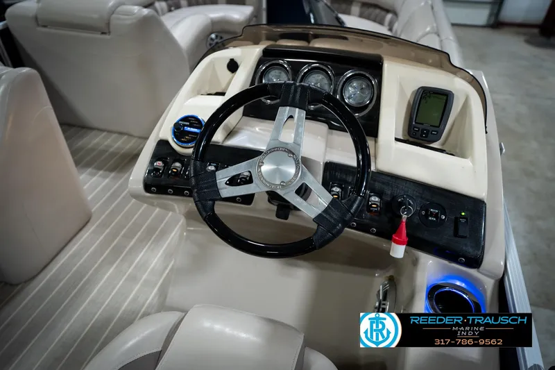 Slide: The Image of 2016 Bennington 2375 RSB pontoon boat interior with blue privacy curtain in showroom. - 32