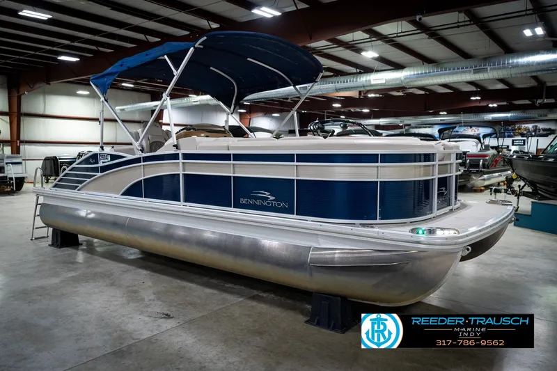 Slide: The Image of 2016 Bennington 2375 RSB pontoon boat in showroom, blue and white design. - 5