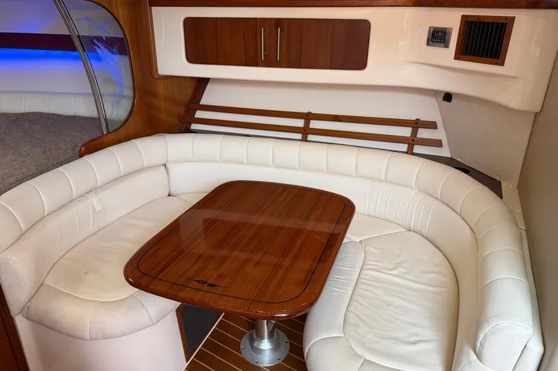Slide: The Image of Luxurious 2008 Grady-White Express 360 cabin with elegant seating and wooden table. - 13