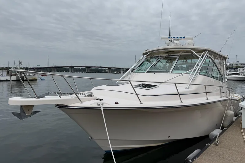 Slide: The Image of 2008 Grady-White Express 360 boat docked in a marina under cloudy skies. - 4