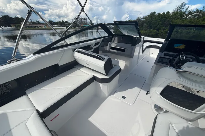 Slide: The Image of 2025 Cobalt R4 Outboard boat interior with sleek white seating and modern dashboard. - 10