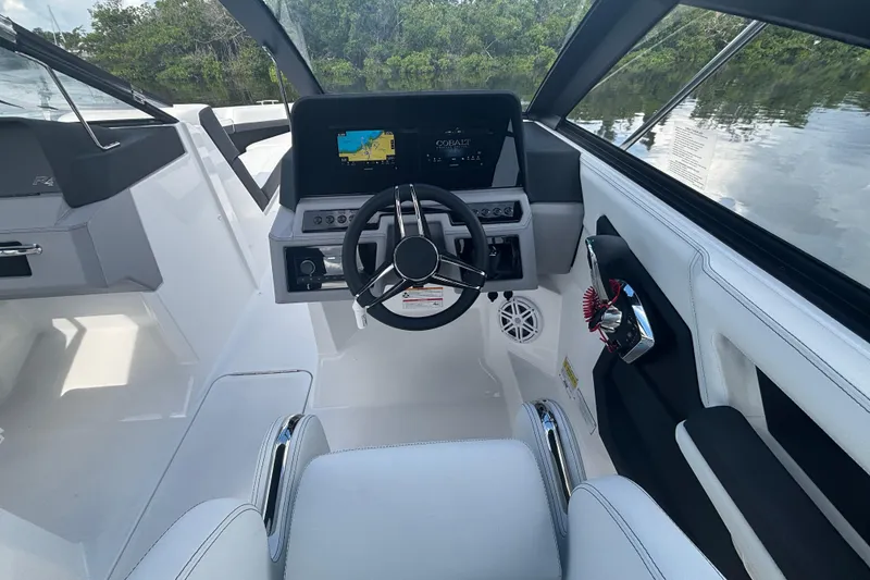 Slide: The Image of 2025 Cobalt R4 Outboard boat cockpit with modern steering and navigation system. - 13