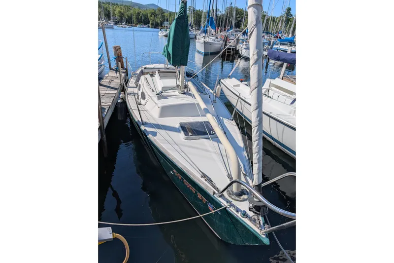Slide: The Image of 2001 Alerion 28 sailboat docked at a marina, surrounded by other boats. - 1