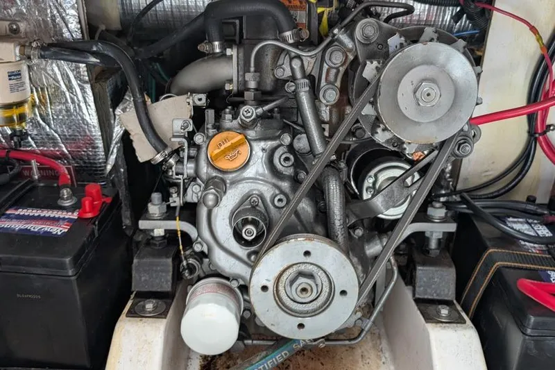 Slide: The Image of Engine compartment of a 2001 Alerion 28 sailboat, featuring a detailed view of the engine. - 10