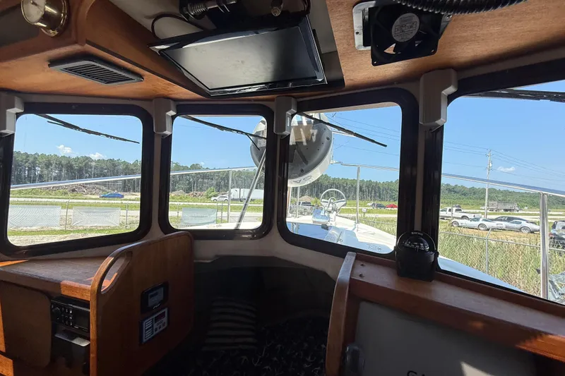Slide: The Image of 2013 Ranger Tugs R27 Classic interior with dining area and wooden accents. - 17