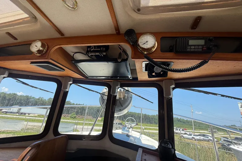 Slide: The Image of 2013 Ranger Tugs R27 Classic interior with kitchen, stove, and seating area. - 18