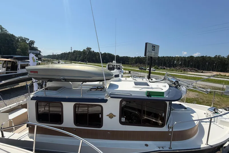 Slide: The Image of Cozy cabin interior of 2013 Ranger Tugs R27 Classic with anchor-patterned bedding. - 21