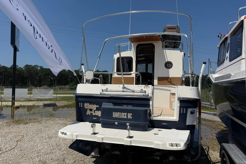 Slide: The Image of 2013 Ranger Tugs R28 Classic boat with rooftop equipment, parked outdoors on a sunny day. - 3