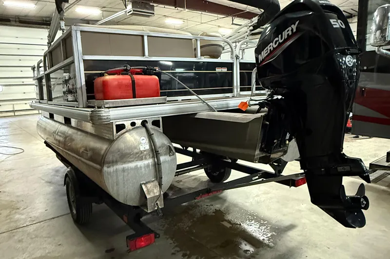 Slide: The Image of 2021 Sun Tracker Bass Buggy 16 XL pontoon boat with Mercury 50 engine in a garage. - 3