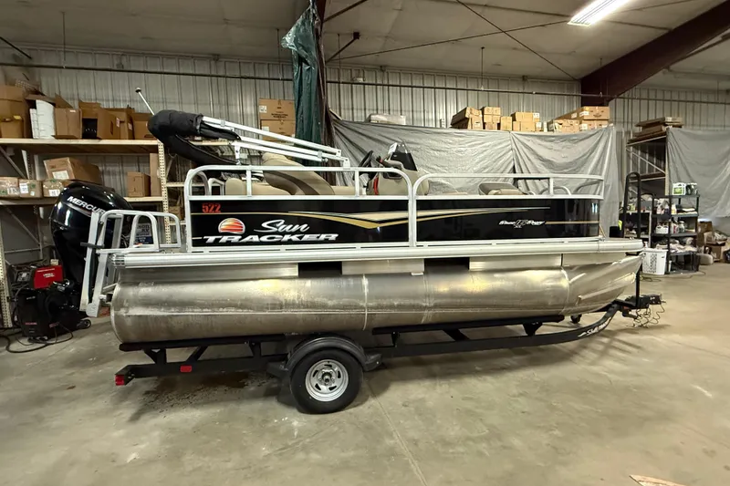 Slide: The Image of 2021 Sun Tracker Bass Buggy 16 XL pontoon boat in a storage facility. - 7