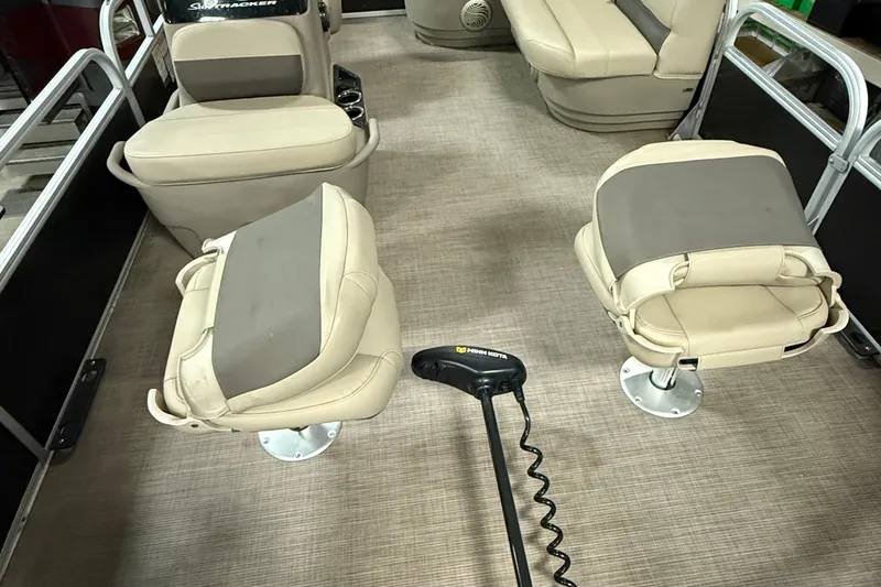 Slide: The Image of 2021 Sun Tracker Bass Buggy 16 XL interior with beige seating and Minn Kota trolling motor. - 8