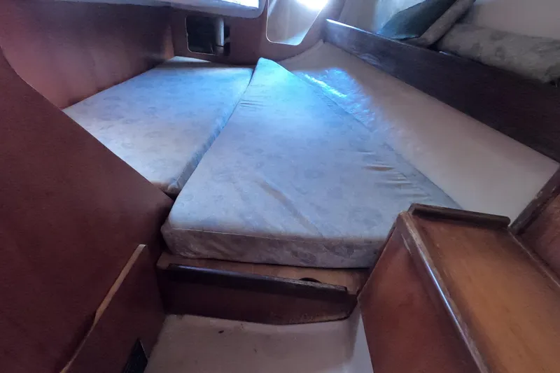 Slide: The Image of Interior cabin of 1985 Beneteau First 29 sailboat with twin berths and wooden finish. - 13