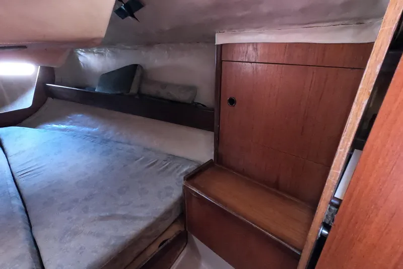 Slide: The Image of Cozy cabin interior of 1985 Beneteau First 29 sailboat with wooden cabinetry. - 14