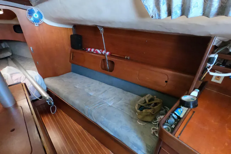 Slide: The Image of Interior of 1985 Beneteau First 29 sailboat with wooden furnishings and cozy seating area. - 17